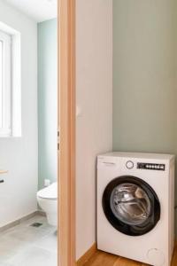 a washing machine in a bathroom with a toilet at Skiathou 12 Contemporary Residences in Athens