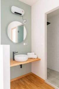 a bathroom with a sink and a mirror at Skiathou 12 Contemporary Residences in Athens