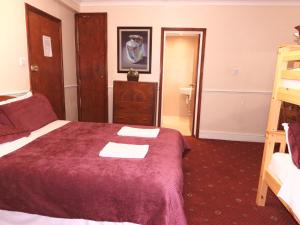 a hotel room with a bed and a ladder at Europa House Hotel, London Paddington in London