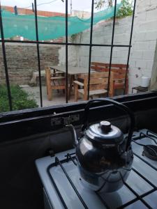 a tea kettle sitting on a stove top oven at Casa Norte in Diamante