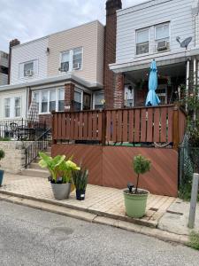 a house with a wooden fence and potted plants at Cozy airport area hideaway in Philadelphia