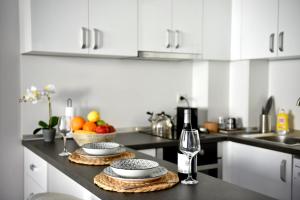 a kitchen counter with two plates and a bottle of wine at Морски Бриз in Varna City