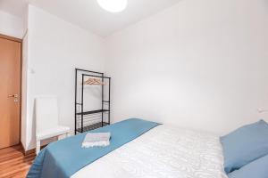 a bedroom with a blue and white bed and a mirror at The Most Central In Venice [ San Marco Rialto ] in Venice