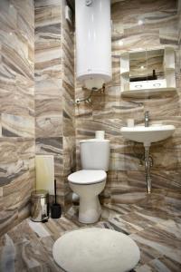 a bathroom with a toilet and a sink at Морски Бриз in Varna City