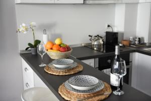 a kitchen counter with two plates and a basket of fruit at Морски Бриз in Varna City +16 photos