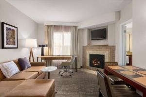 a living room with a couch and a fireplace at Residence Inn Chattanooga Near Hamilton Place in Chattanooga