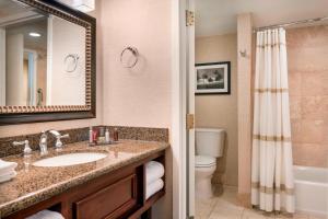 a bathroom with a sink and a toilet and a mirror at Las Vegas Marriott in Las Vegas