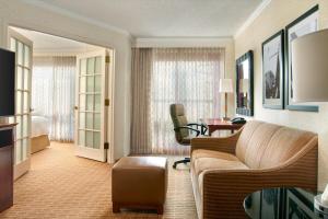 a living room with a couch and a desk in a hotel room at Atlanta Marriott Suites Midtown in Atlanta