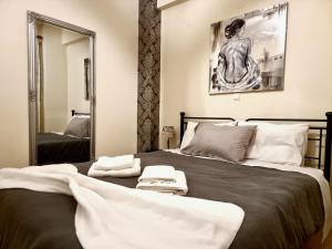 a bedroom with a large bed with towels on it at in centre suite in Tripoli