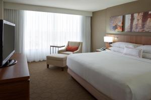 a hotel room with a large bed and a television at Delta Hotels by Marriott Toronto Airport & Conference Centre in Toronto