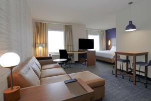 a hotel room with a couch and a bed at Residence Inn by Marriott Colorado Springs First & Main in Colorado Springs