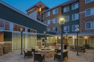 a hotel patio with a fire pit and tables and chairs at Residence Inn by Marriott Colorado Springs First & Main in Colorado Springs
