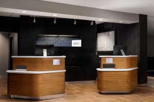 a lobby with wooden counters and a black wall at Courtyard by Marriott Denver Central Park in Denver