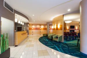 a lobby of a hotel with chairs and a bar at SpringHill Suites Charlotte Lake Norman/Mooresville in Mooresville