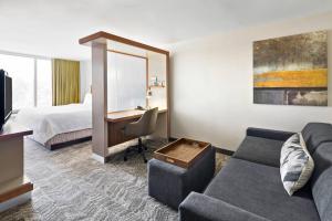 a hotel room with a couch and a bed and a desk at SpringHill Suites by Marriott Flagstaff in Flagstaff