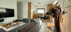 a living room with a couch and a table at BAST 17 DOM duży parking , Mandoria , PTAK , 2 Sypialnie lub 1 sypialnia, taras , Autostrada A1, Kalinowskiego 17E WIFI in Łódź
