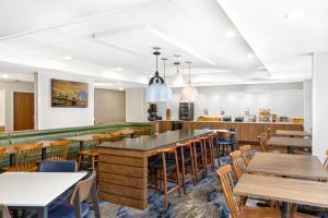 une salle à manger avec des tables et des chaises en bois dans l'établissement Fairfield Inn by Marriott Evansville East, à Evansville