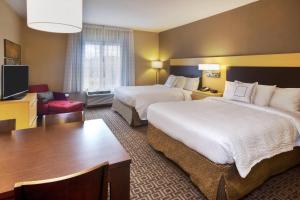 a hotel room with two beds and a desk at TownePlace Suites by Marriott Franklin Cool Springs in Franklin
