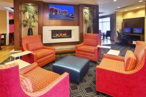 a lobby with chairs and a fireplace in a hotel at TownePlace Suites by Marriott Franklin Cool Springs in Franklin