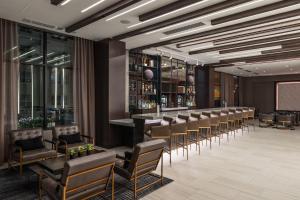 a bar in a hotel lobby with chairs and a podium at AC Hotel by Marriott Worcester in Worcester