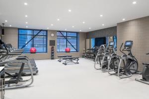 a fitness room with treadmills and exercise equipment at AC Hotel by Marriott Worcester in Worcester