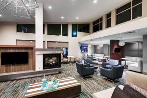 a lobby with couches and a fireplace at Residence Inn by Marriott Austin Airport in Austin