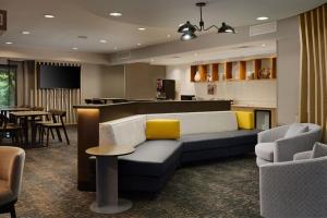 a living room with a couch and a bar at SpringHill Suites Nashville MetroCenter in Nashville
