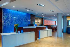 a lobby of an office with a blue wall at Fairfield Inn & Suites by Marriott Atlanta Cumming/Johns Creek in Cumming