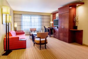 a hotel room with a couch and a table at Courtyard by Marriott Lexington Keeneland/Airport in Lexington