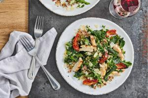 a table topped with plates of food with a salad at Courtyard by Marriott Kalamazoo Portage in Portage