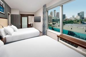 a hotel room with two beds and a large window at SpringHill Suites by Marriott Atlanta Downtown in Atlanta