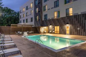 a swimming pool in front of a building at Courtyard by Marriott Charleston-North Charleston in Charleston
