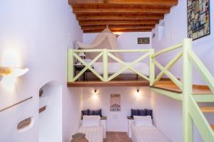a room with a bunk bed and a staircase at Villa Matakia in Áno Potamiá