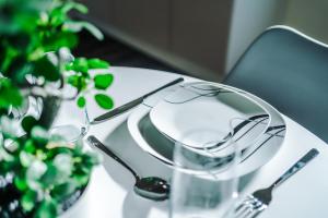 a table with glasses and a plate with a plant at Videl Homes in Manchester