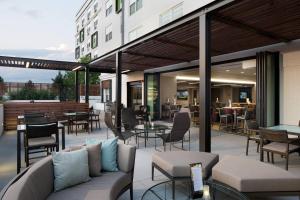 an outdoor patio with tables and chairs and tablesktop at Courtyard Denver Airport at Gateway Park in Aurora