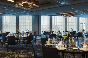 a banquet room with tables and chairs and chandeliers at Renaissance Allentown Hotel in Allentown