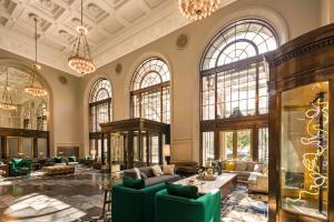 a large lobby with couches and tables and windows at The Notary Hotel, Philadelphia, Autograph Collection in Philadelphia