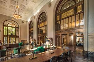 a large room with tables and chairs in a building at The Notary Hotel, Philadelphia, Autograph Collection in Philadelphia