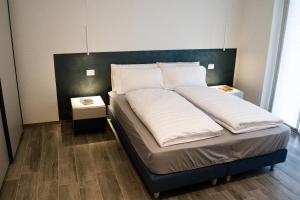 a bed with two pillows on it in a room at Ca’ del Riccio Blu in Bra