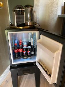 Elle comprend un petit réfrigérateur rempli de nombreuses boissons. dans l'établissement La chambre et le studio du château du golf de Bernalmont, à Liège