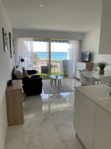 a living room with a view of the ocean at Front de mer,plage, piscine, parking in Cagnes-sur-Mer