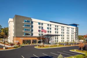 an empty parking lot in front of a hotel at Aloft Framingham in Framingham