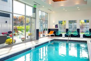 a swimming pool in a house with a large window at Aloft Framingham in Framingham