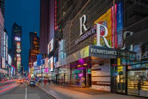 a busy city street at night with buildings at Renaissance New York Times Square Hotel in New York