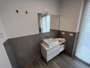 a bathroom with a sink and a mirror at Ca’ del Riccio Blu in Bra
