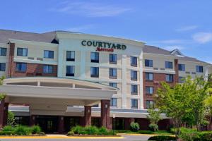a hotel with a sign on the front of a building at Courtyard by Marriott Winchester Medical Center in Winchester