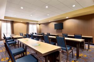 a conference room with tables and chairs and a tv at Courtyard by Marriott Stafford Quantico in Triangle
