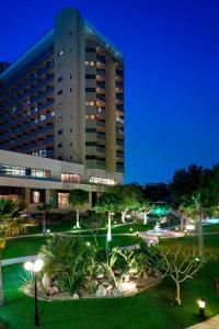 a large building with a park in front of it at Le Meridien Al Khobar in Al Khobar