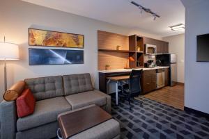 a living room with a couch and a table and a kitchen at TownePlace Suites by Marriott Jackson in Jackson