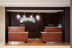 a lobby with wooden counters and a plant on the wall at Courtyard by Marriott Portland Southeast/Clackamas in Clackamas